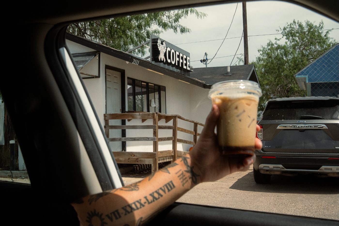 Iced coffee handed through a car window at the 956 drive-thru
